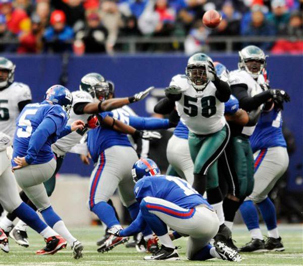 Eagles defensive end Trent Cole (58) blocks a field goal attempt by Giants' John Carney